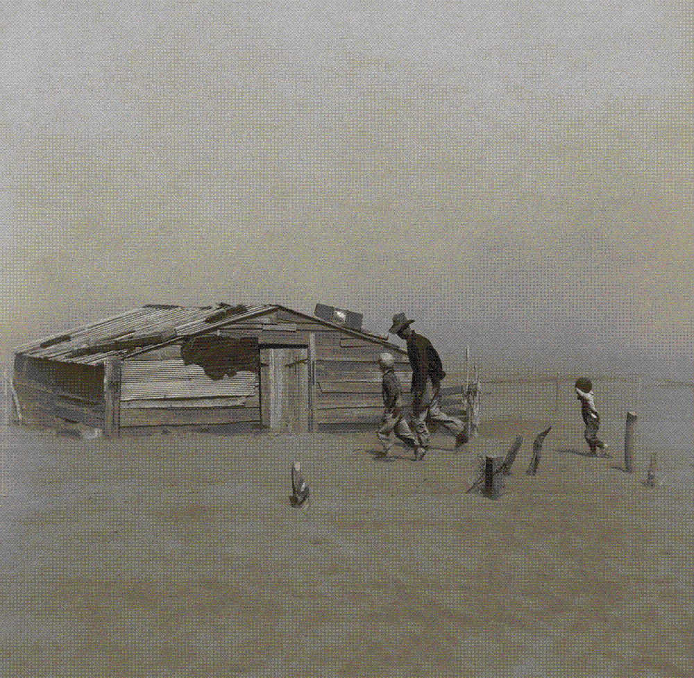 A farmer and his two sons walk through a dust storm toward a half-buried outbuilding in Cimarron County, Oklahoma, 1936.