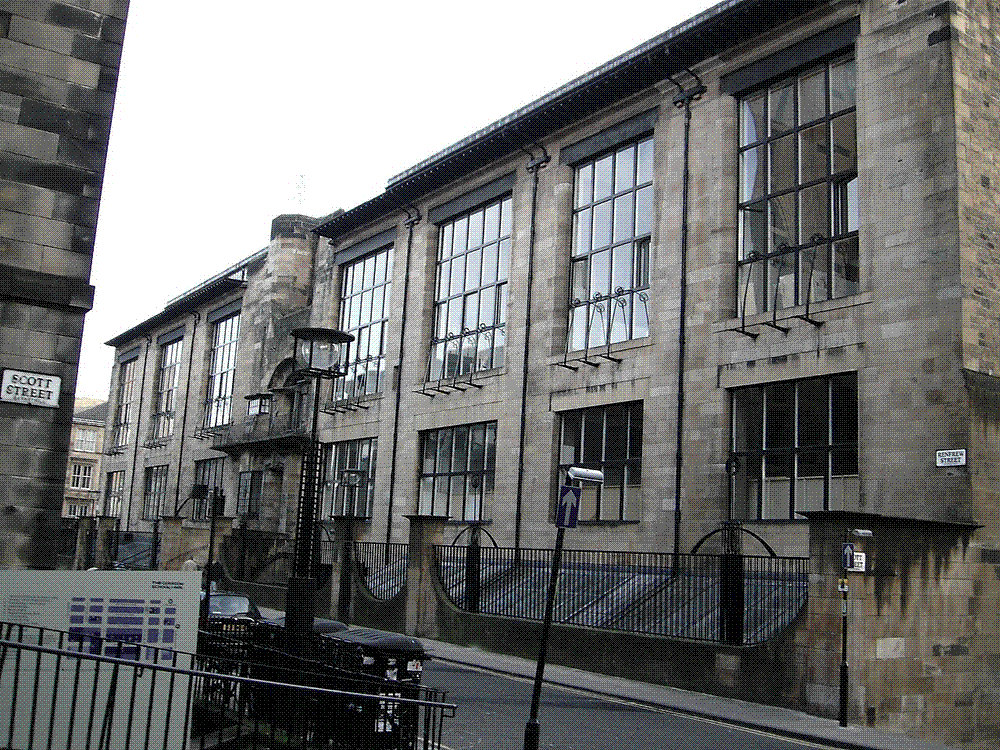 The stone-and-glass facade of Charles Rennie Mackintosh's Glasgow School of Art building, with its tall studio windows.