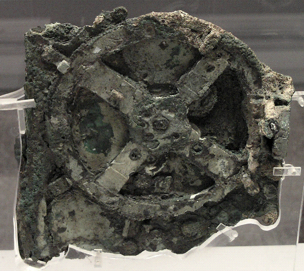 The largest surviving fragment of the Antikythera Mechanism, corroded bronze gearwork recovered from the 1900 shipwreck, in the National Archaeological Museum, Athens