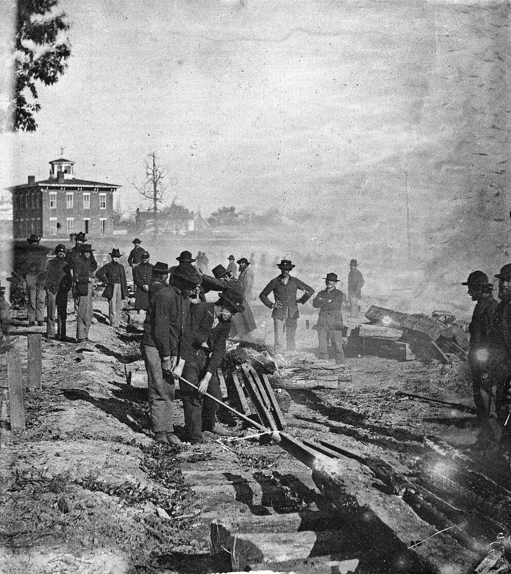 Union soldiers tearing up railroad tracks in Atlanta in 1864, twisting the heated rails so they cannot be relaid.