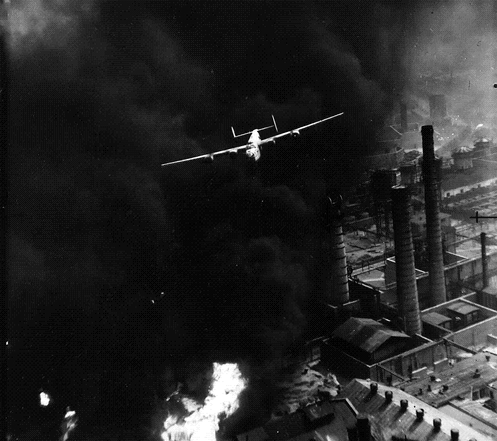 A U.S. B-24 Liberator emerges from billowing smoke above a burning oil refinery at Ploiesti, Romania, August 1943.