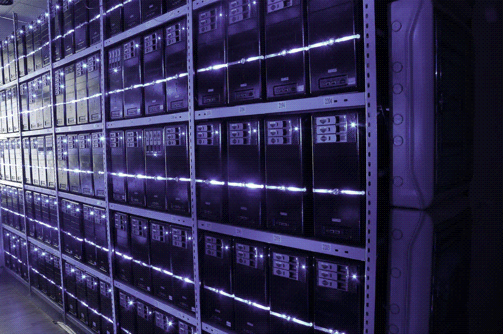 A data-center server hall with rows of racks, illustrating AI model inference.