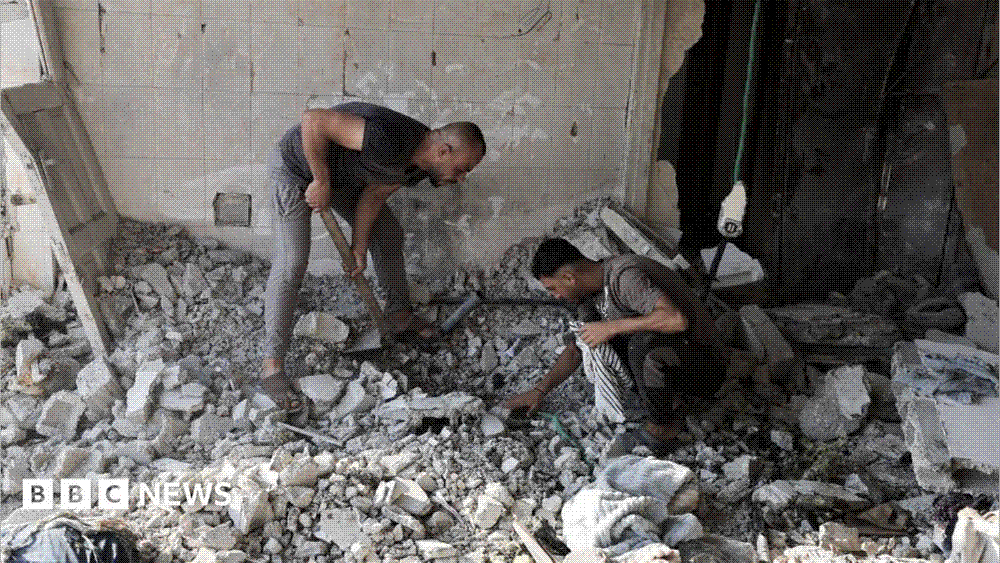 Two men dig through the broken concrete and rubble of a destroyed tiled room after an Israeli airstrike in Gaza.