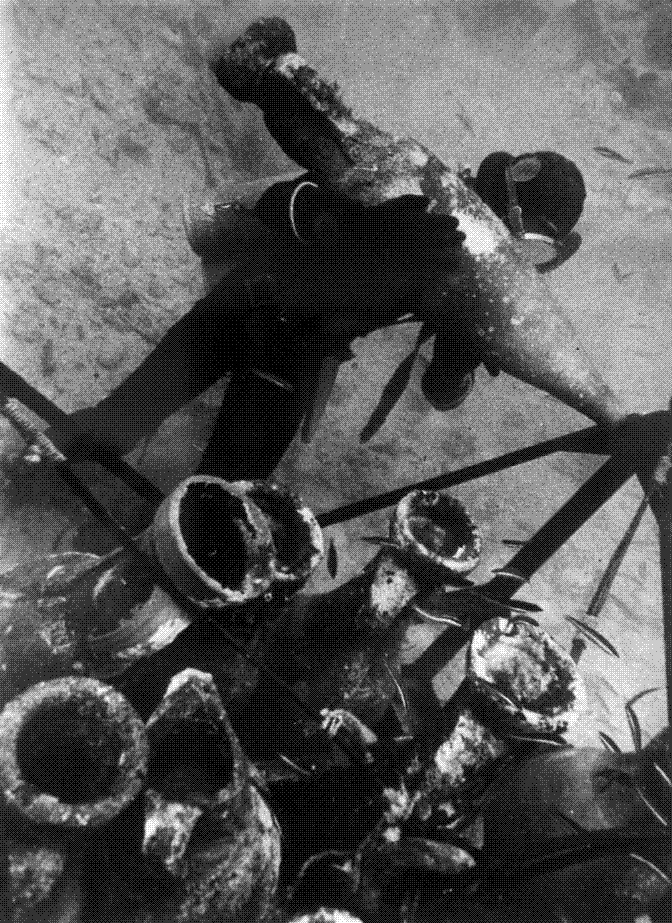 Rows of ancient amphorae lying stacked on the seabed at a Mediterranean wreck site